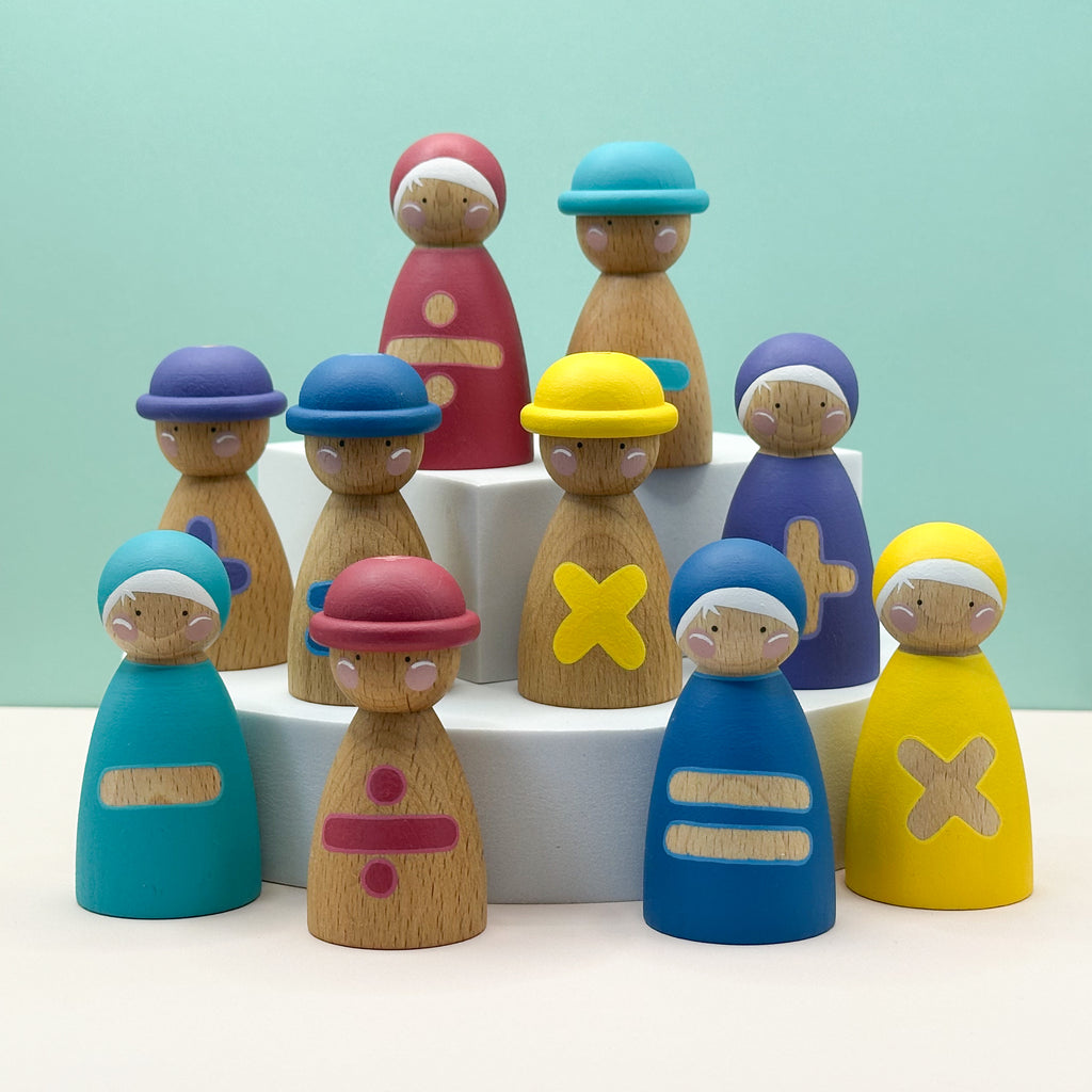 Colorful wooden peg dolls with hats and mathematical symbols on a light blue background