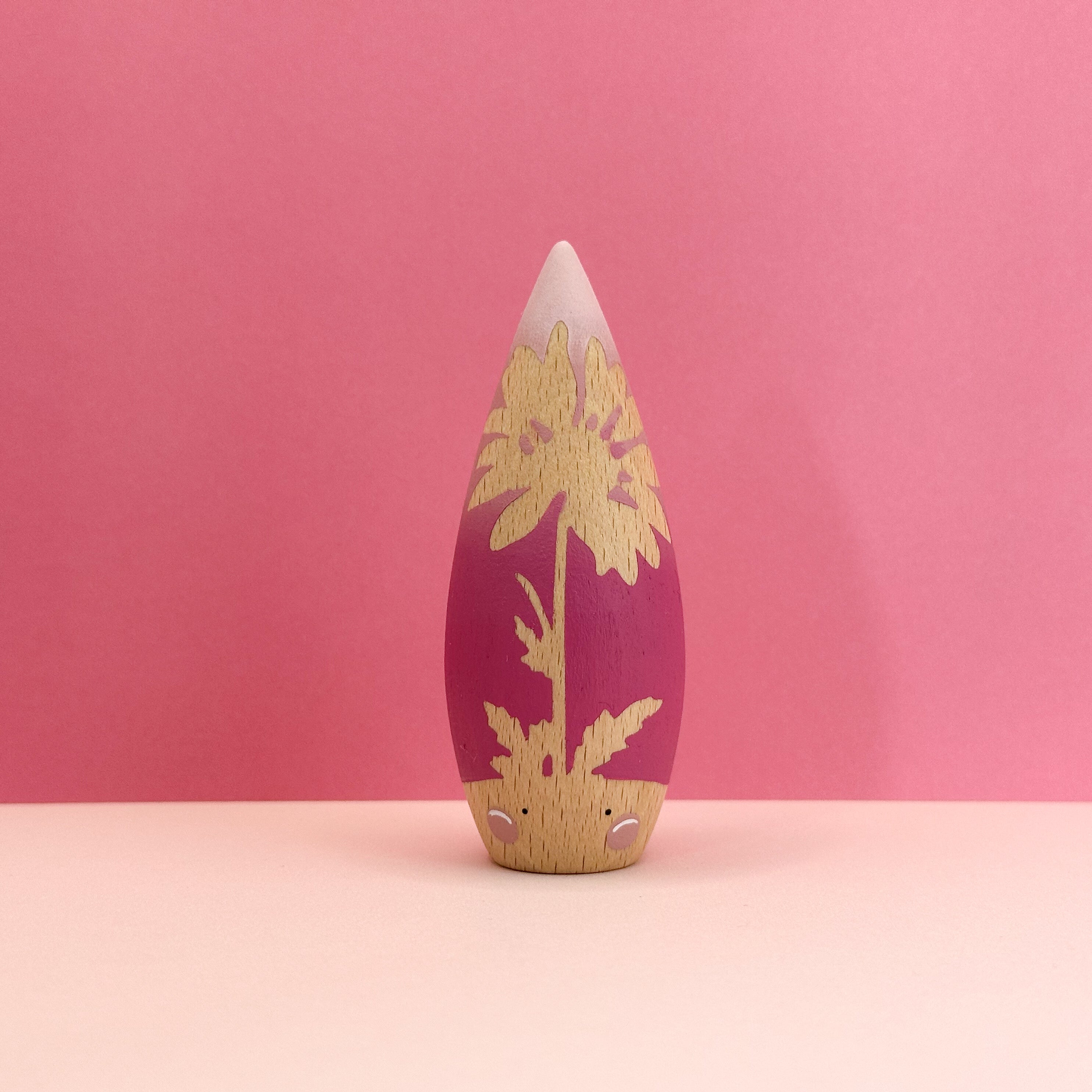 Decorative object with floral design on a pink background