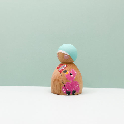 Wooden peg doll with a pink flamingo design on a light green background