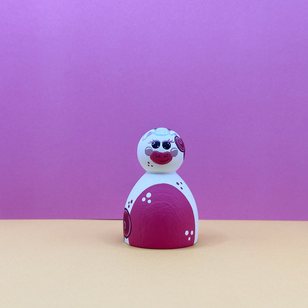 Toy figure with a red and white design on a purple background