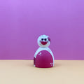 Toy figure with a red and white design on a purple background