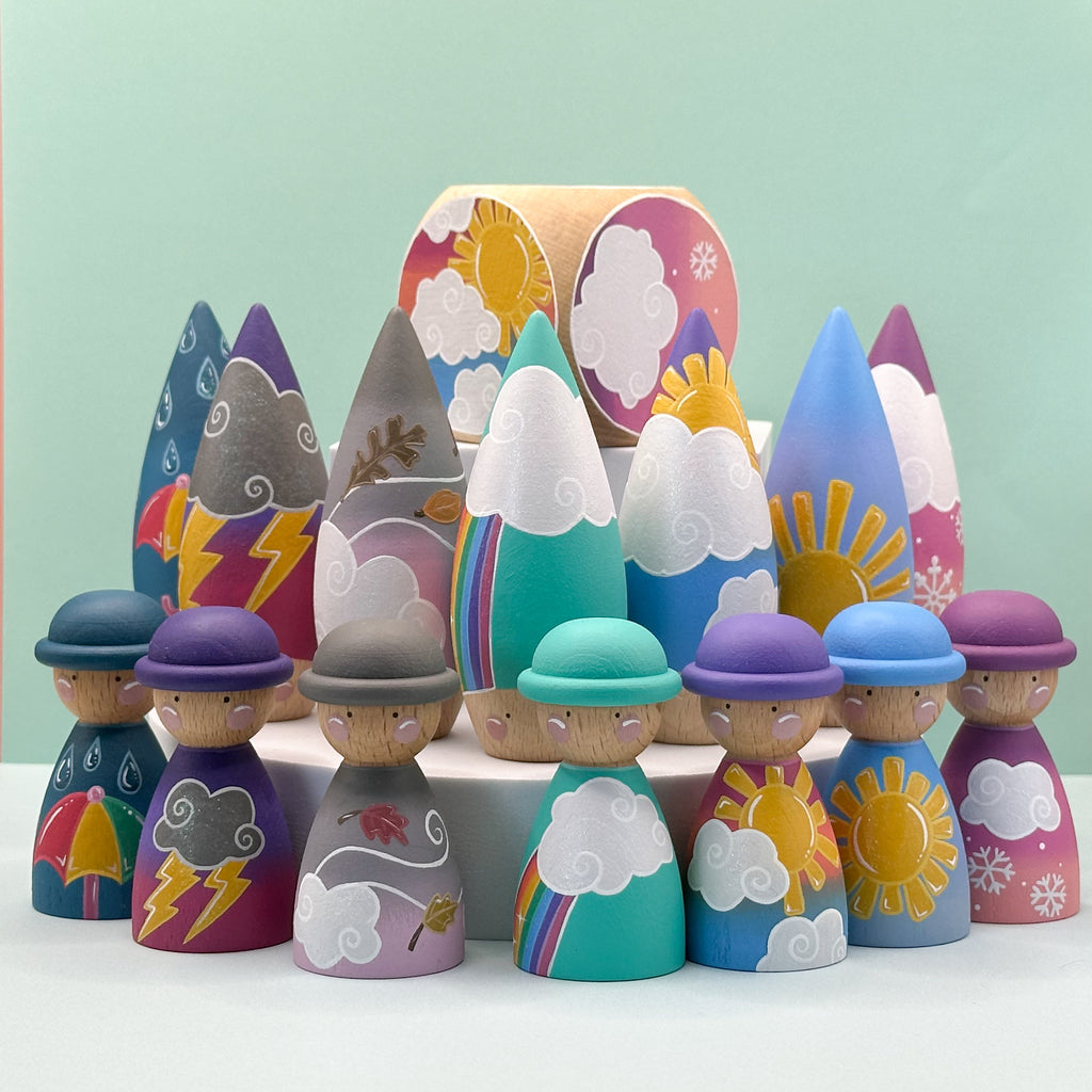 Colorful wooden peg dolls with various designs against a light green background