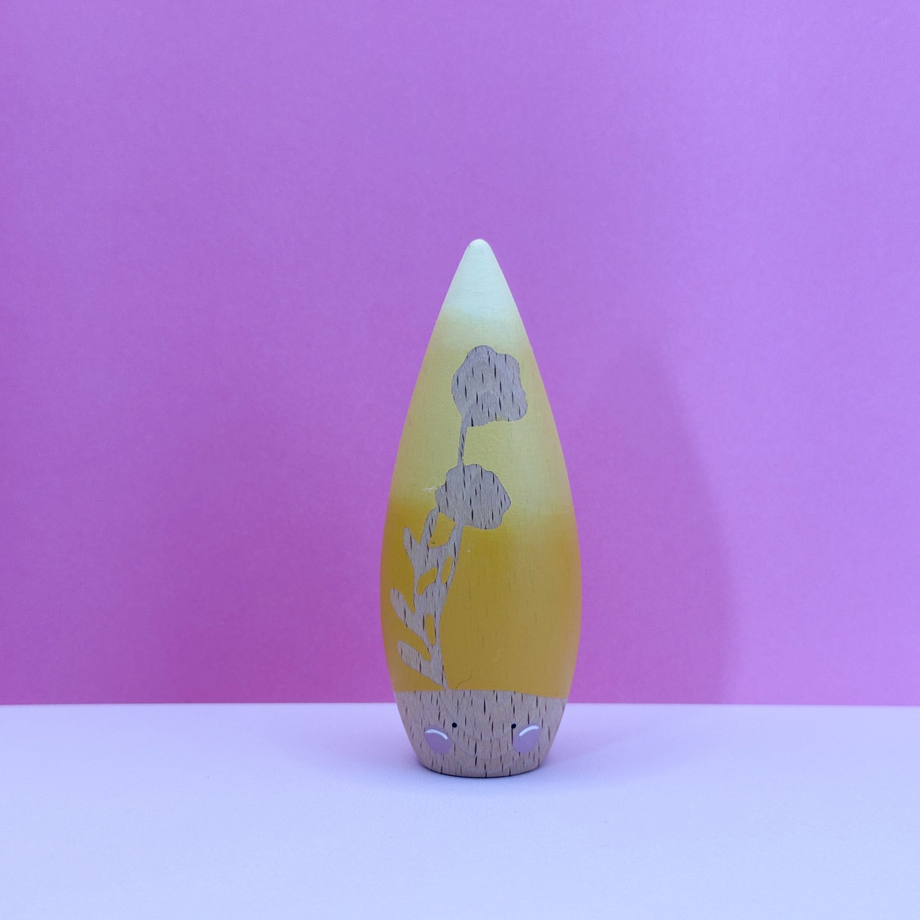 Decorative item with floral design on a pink background