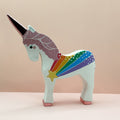 Wooden unicorn figurine with rainbow pattern on a beige background
