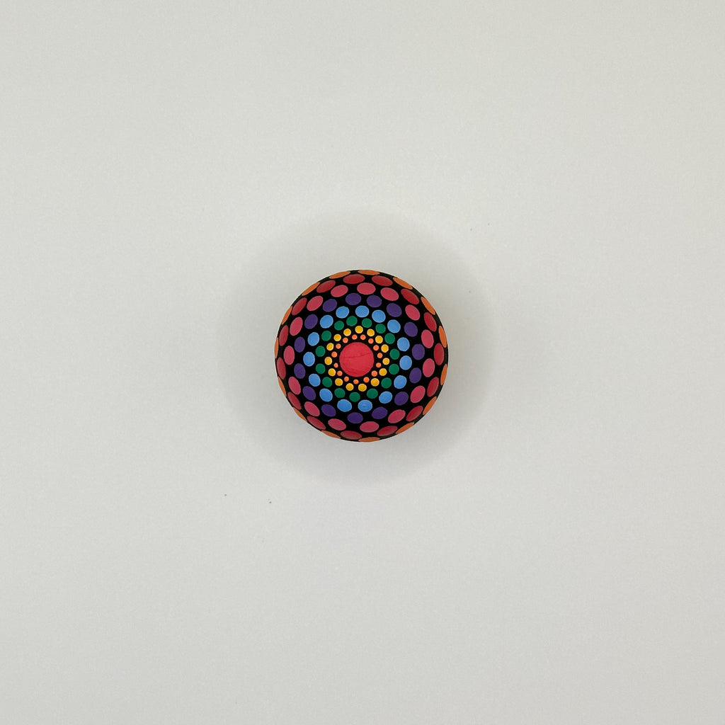 Colorful polka dot ball on a light gray background