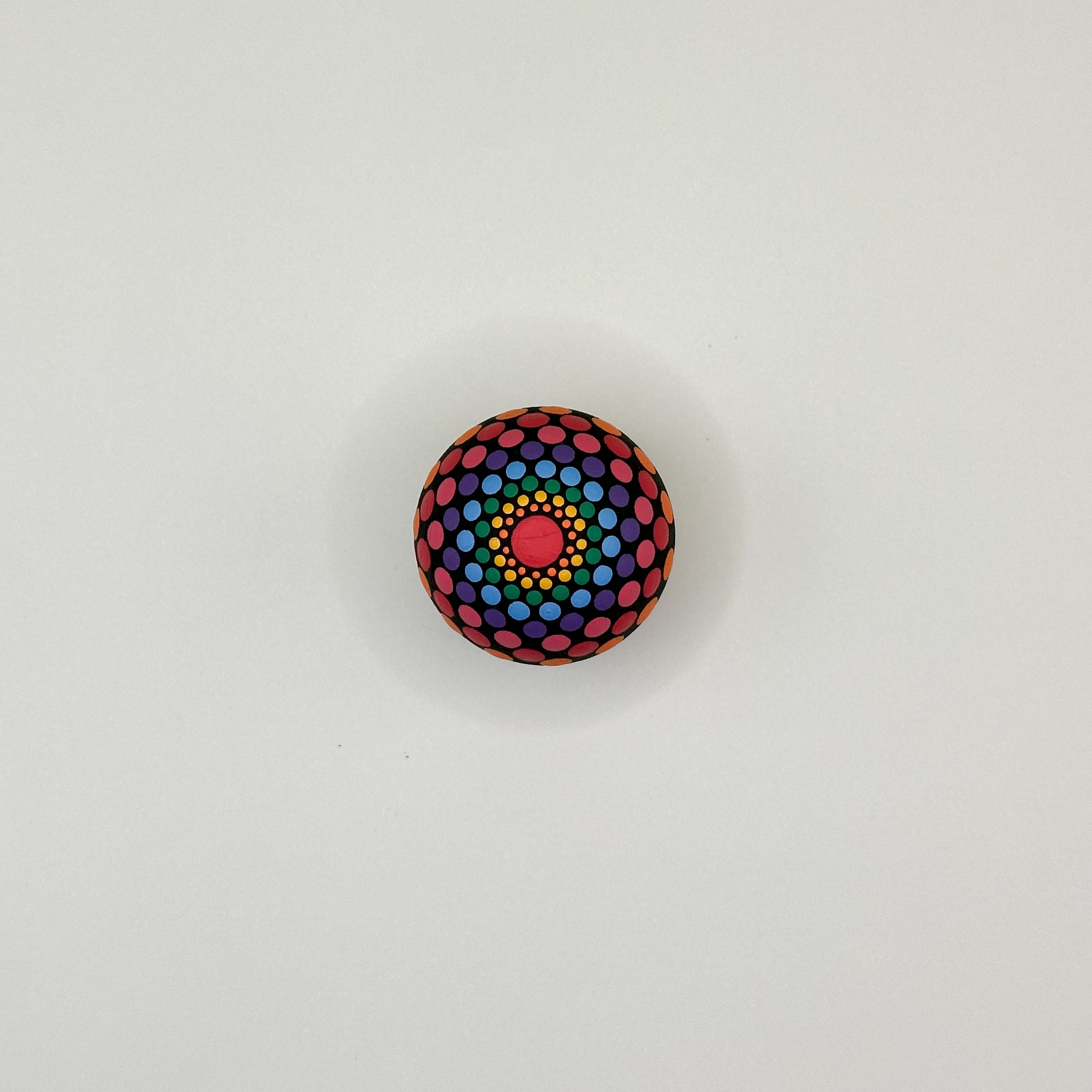 Colorful polka dot ball on a light gray background