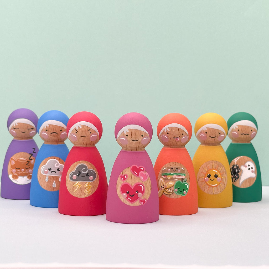 Set of colorful wooden peg dolls with various designs representing feelings on a light green background