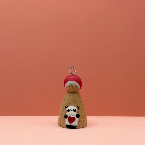 Small peg doll keyring with a panda holding a heart sign painted on its body with a peach background