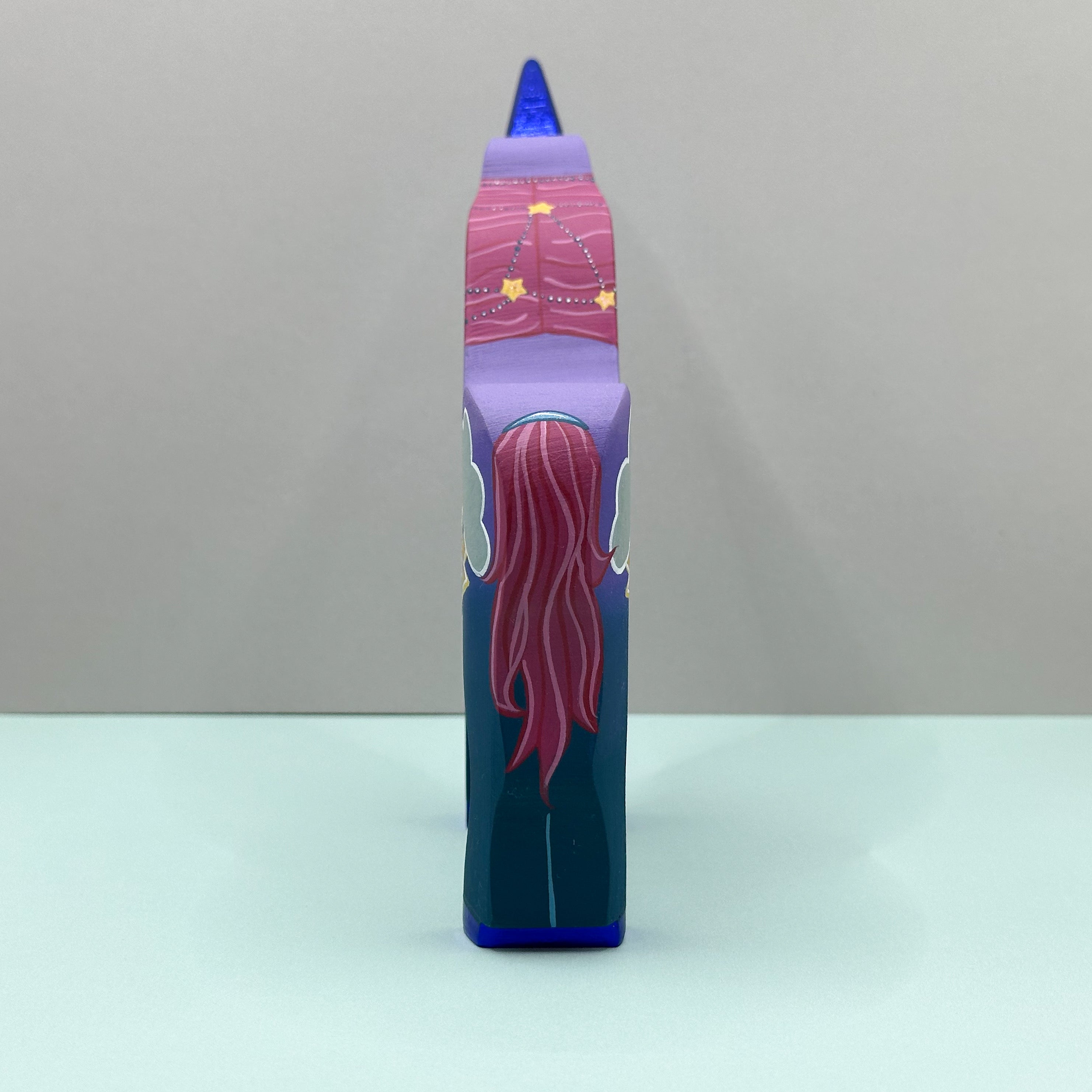 Colorful unicorn with a pink tail on a gray background