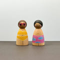 Two wooden peg dolls in swimwear