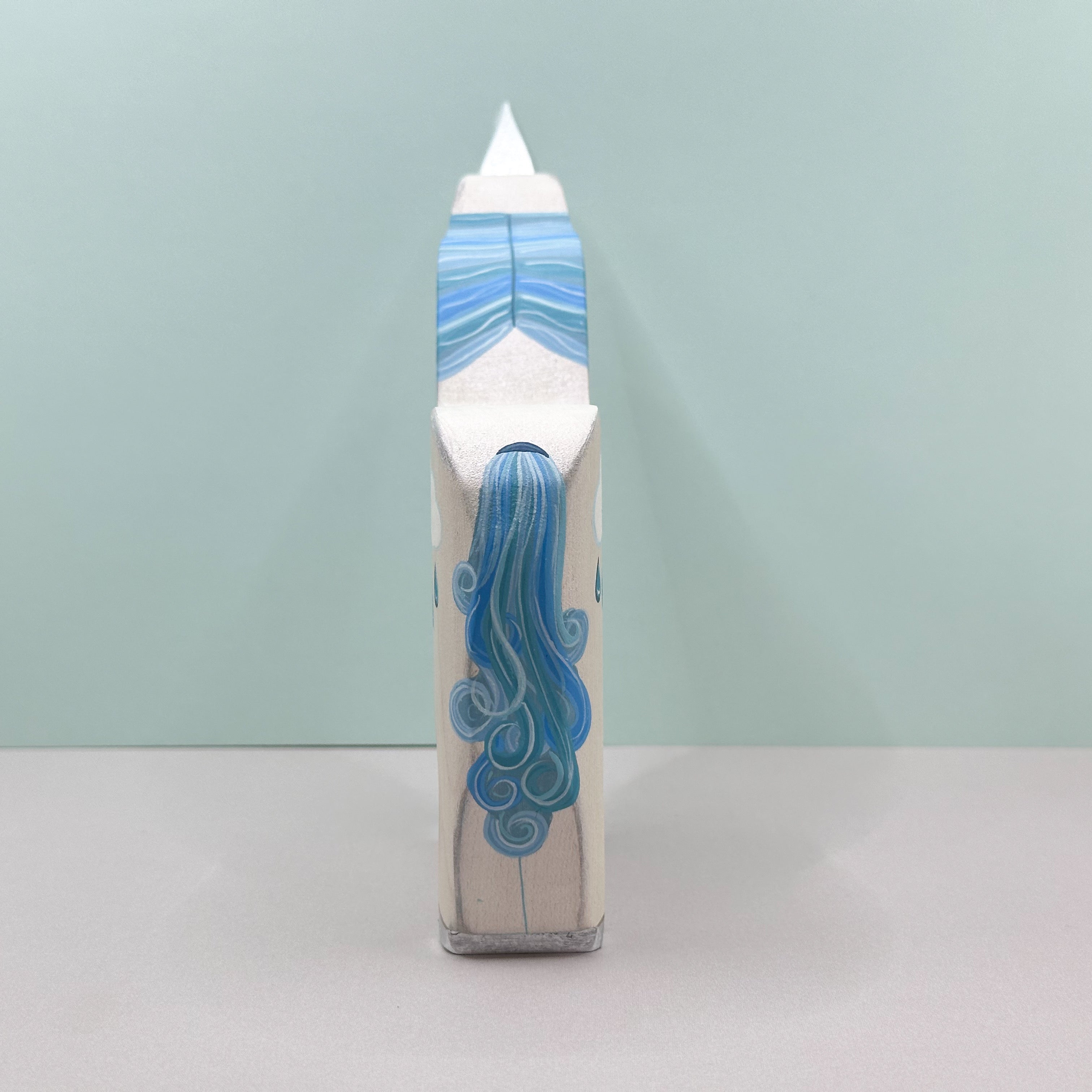 Cylindrical product with blue design on a light gray background