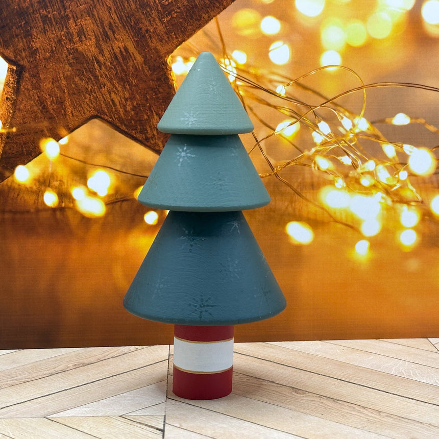 Decorative Christmas tree with a star and string lights in the background
