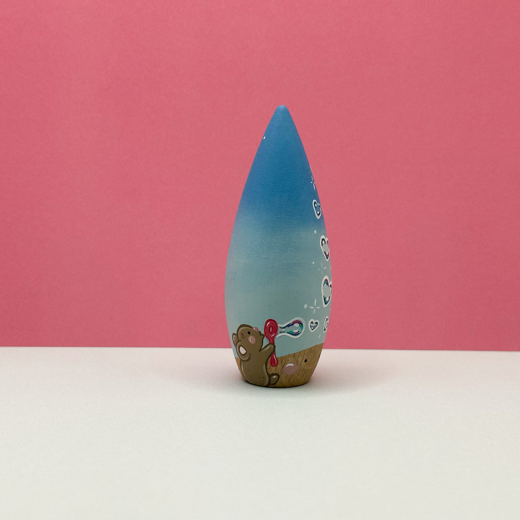 Blue decorative object with a pink background